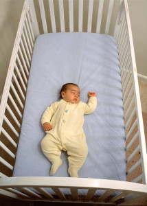 baby in a full-size crib, nursery