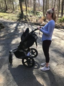 woman lifting a jogging stroller